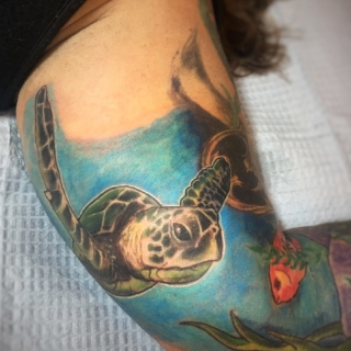 Tattoo: turtle swimming in ocean