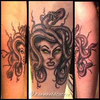 Tattoo: shaded Medusa head with green eyes