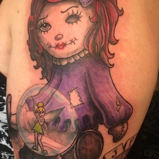 Tattoo: old doll and tinkerbell inside a glass dome