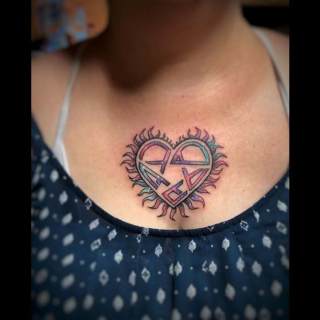 Tattoo: artistic heart on woman's chest