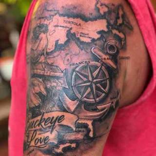 Tattoo: greyscale artwork depicting old map and compass